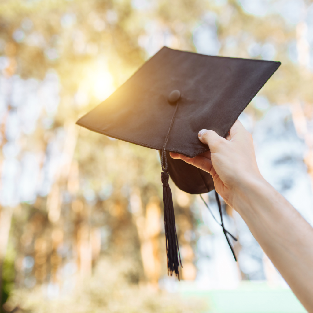 graduation cap being thrown up into the air.