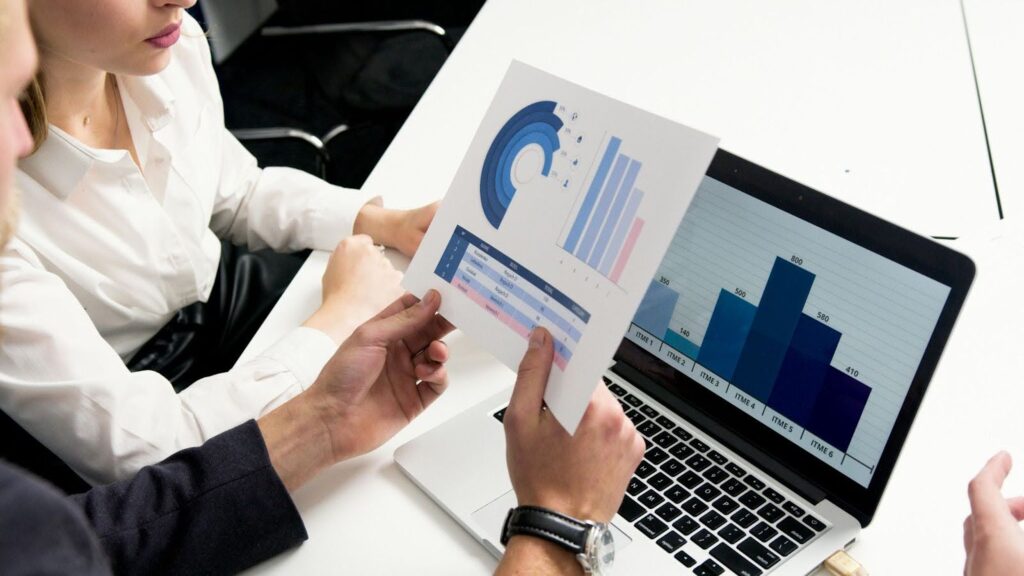 Two people looking at business reports