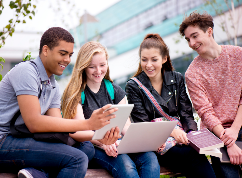 4 People sitting in a group that are looking at a piece of paper