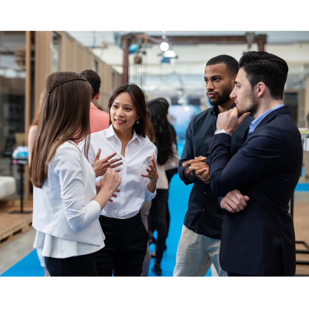 Four People Standing in a Circle Talking