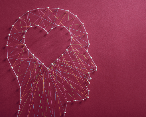 Pin art in the shape of a face with a heart outlined in it