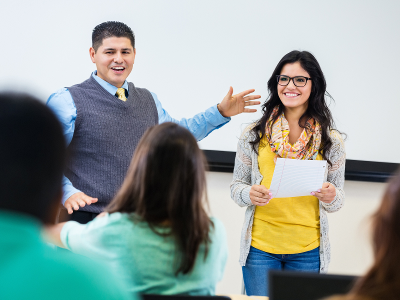 Foundation leader introducing a mentorship sign-up event in a school auditorium.