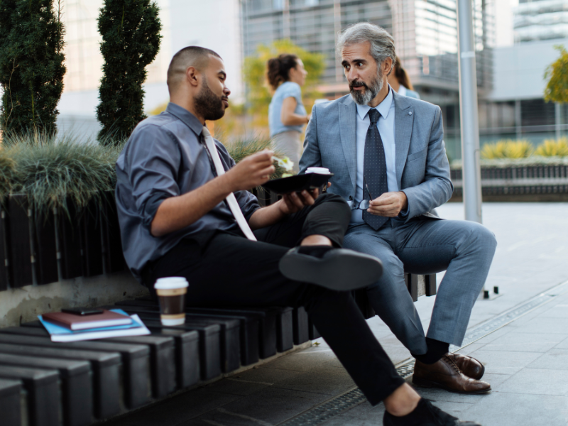 A mentor and mentee laughing together during a leadership workshop.