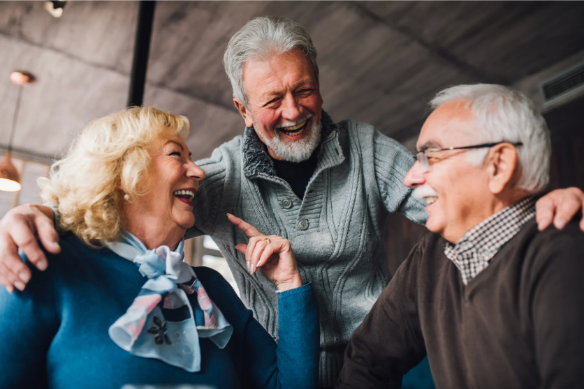 Group of alumni laughing together at a reunion event