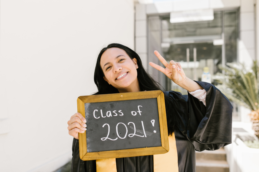 Smiling K12 graduate capturing the moment students become part of their school’s alumni community.