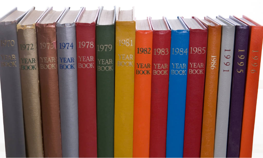 Colorful yearbooks arranged by graduation year, symbolizing alumni memories and engagement through the decades.