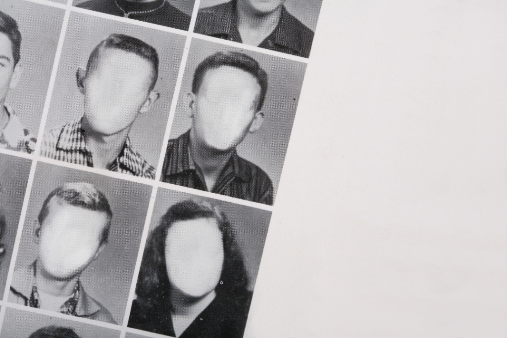 Open school yearbook with student faces blurred, representing alumni memories and school nostalgia.