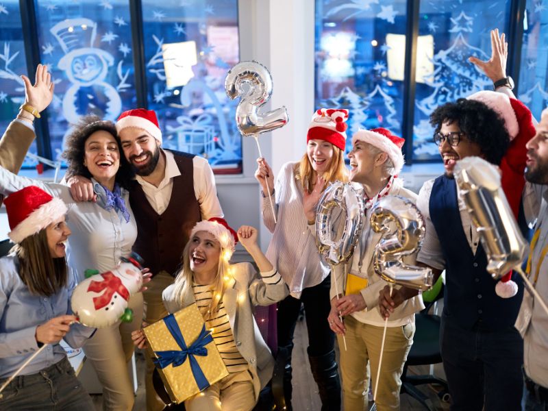 Diverse alumni celebrating at holiday networking event welcoming the new year together