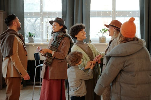 Alumni gathering on school campus during holiday season with vintage yearbook photos displayed