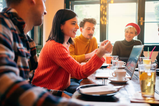 [Alt text: High school alumni reconnecting at coffee shop during holiday season homecoming visit]