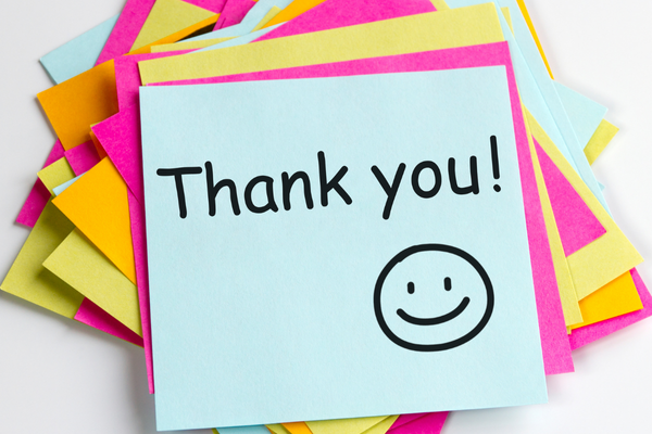 A stack of different bright colored sticky notes.