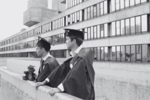 Nostalgic graduation moment with students tossing caps, representing the beginning of lifelong alumni connections
