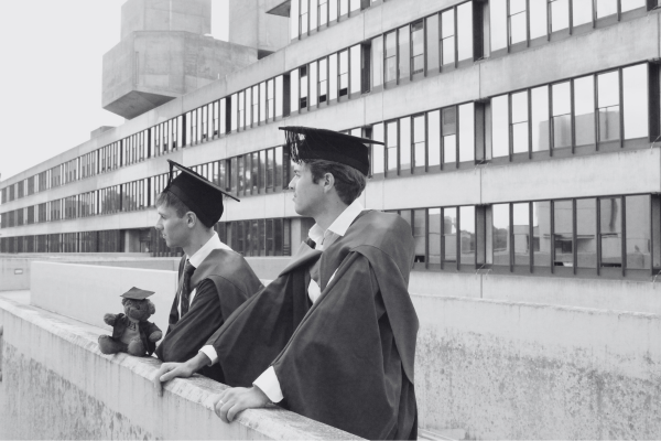 Nostalgic graduation moment with students tossing caps, representing the beginning of lifelong alumni connections