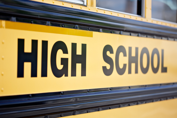 Yellow high school bus representing the school community and student journeys