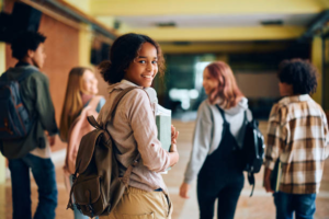 Students smiling and walking through their school halls