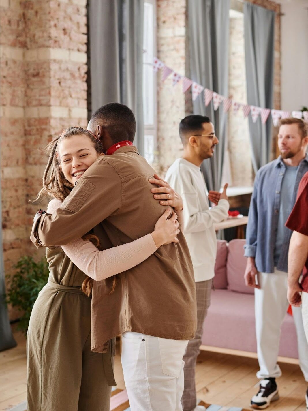 High school alumni celebrating at a reunion, reconnecting with former classmates.
