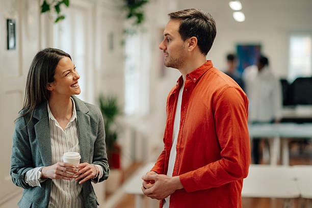 A young alumni professional and mentor having a casual conversation over coffee