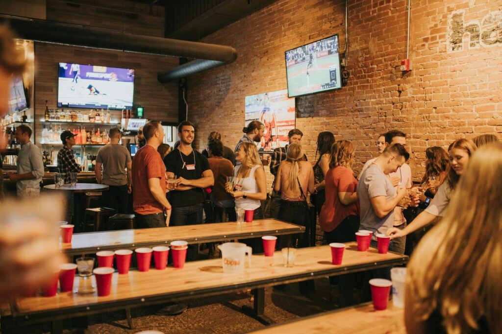A group of happy alumni catching up at a 10 year class reunion