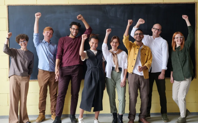 Alumni raising their fist in unity to celebrate their school