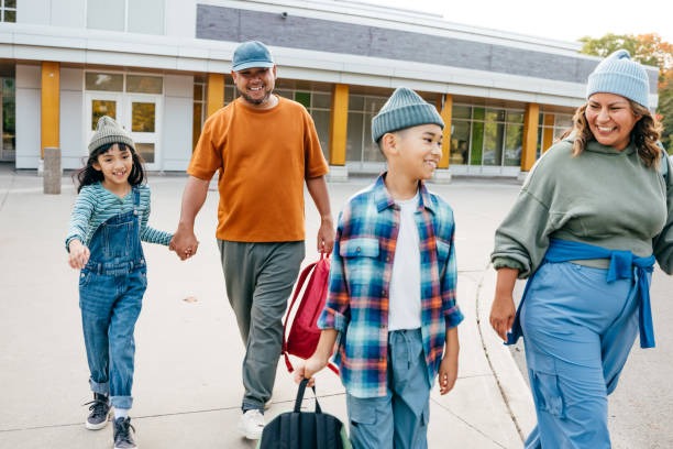 A local family walking their children to campus demonstrating lifelong engagement with their neighborhood school.