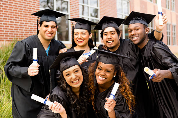 Group of High School Graduates holding diplomas.
