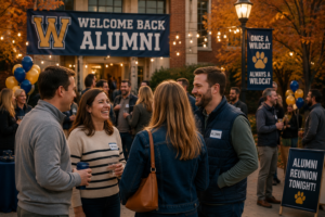 High school alumni reconnecting during a fall alumni event on campus with string lights, school spirit decorations, and autumn colors creating a warm and nostalgic community atmosphere.