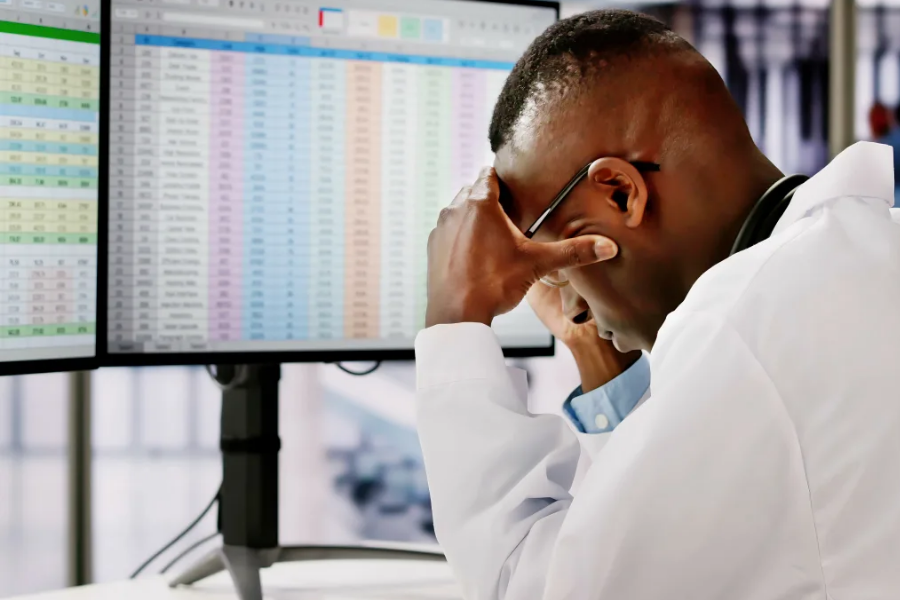 Stressed man looking at spreadsheets